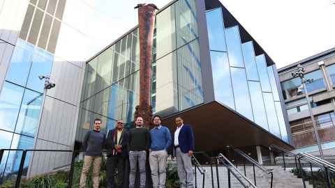 Five men outside the Engineering building.