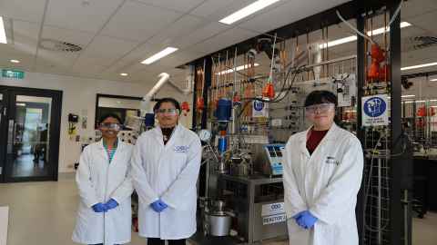 Three people in lab coats.