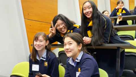 A group of girls in a lecture theatre, wearing Epsom Girls' Grammar School uniforms.