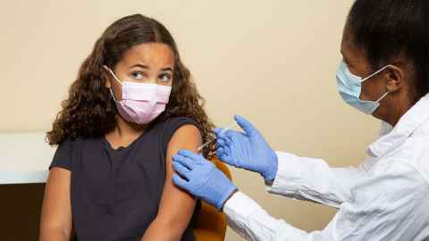 A young girl getting an injection.