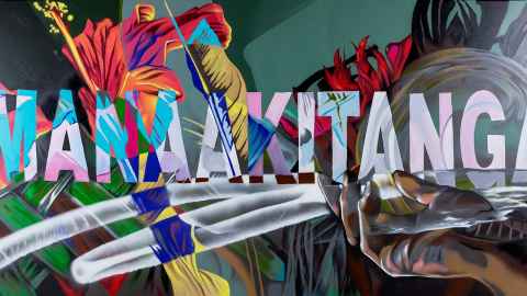 A colourful mural with the word 'Manaakitanga' at the centre.