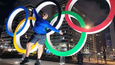  Kanah Andrews-Nahu standing in front of the Olympic rings in Tokyo.