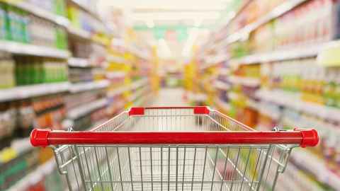 A shopping trolley in a supermarket aisle.