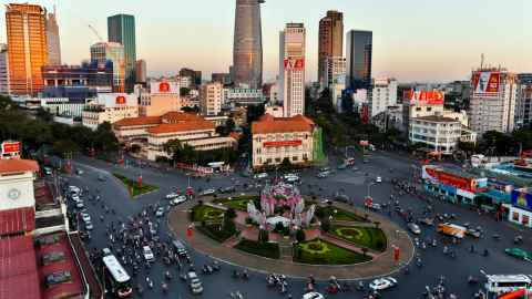 A large, busy roundabout surrounded by tall buildings.