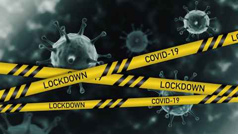 Magnified viruses with yellow tape over them that reads 'Lockdown, Covid-19'.