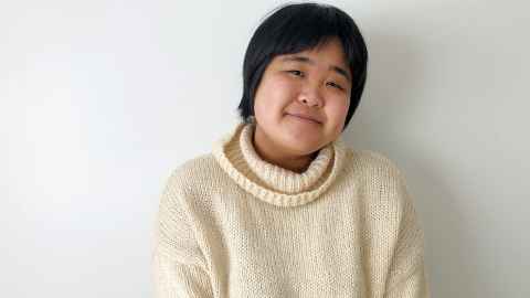 Student Yvonne Ruan wearing a white jumper and semi-smiling 