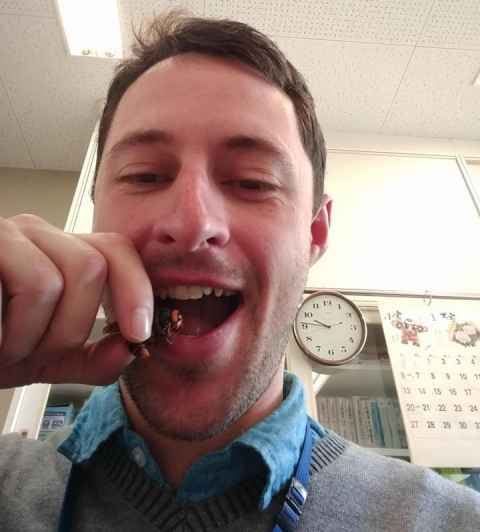 Neil Birrell putting a 'murder hornet' in his mouth.