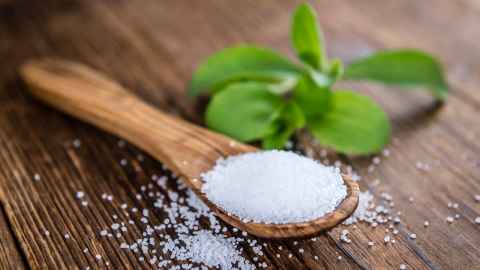 A wooden spoon full of sugar.