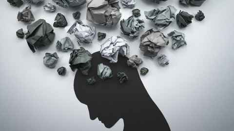 A person's outline in black, with scrunched-up pieces of paper over the head.
