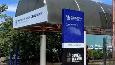 A building entrance with a sign that reads 'Ministry of Social Development: Work and Income'.
