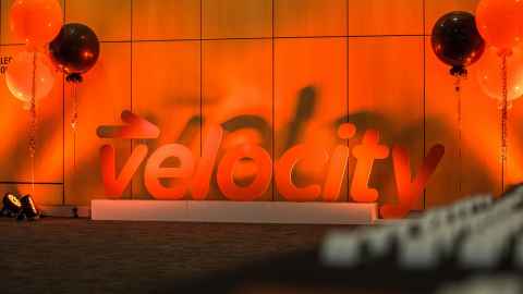 An orange sign that reads: velocity.