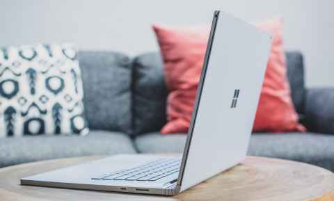 A laptop on a coffee table.