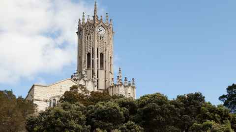 The ClockTower, surrounded by trees, on a fine day.