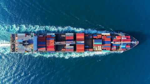 A container ship on the water, from above.