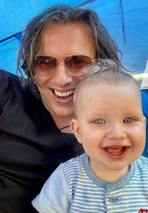 Professor Marek Tesar with a baby.
