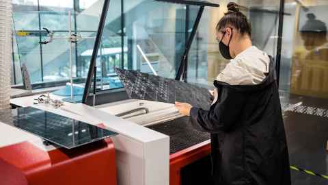 The Pou Iho components are a combination of laser cut and engraved acrylic with hand-stitched and braided flax elements. The patterning references tukutuku panels. PhD Architecture student Savannah Brown is at work at the laser. 