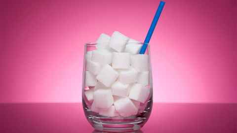 A glass filled with sugar cubes