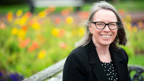 Valerie Linton, with gardens in the background.