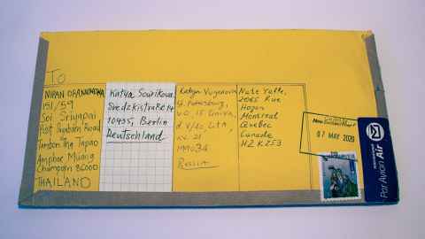A yellow envelope with addresses on it.