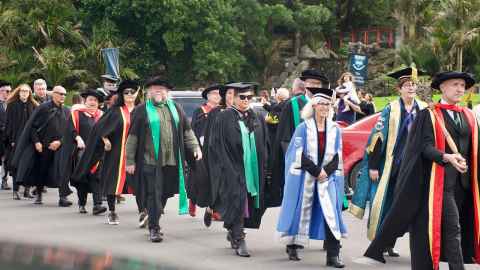 A procession of people in academic regalia, including Vice-Chancellor Dawn Freshwater.