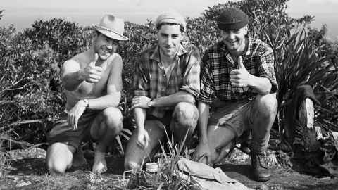 L to R David English, Paul Parish and John Brock celebrating a quick journey to the summit of Little Barrier (1963), Auckland University Field Club (Science) founded in 1922, closed in 1992.