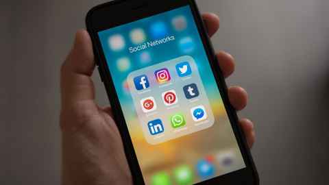 A smartphone screen with the words 'Social Networks' at the top and social media icons including Facebook, Twitter and Instagram.