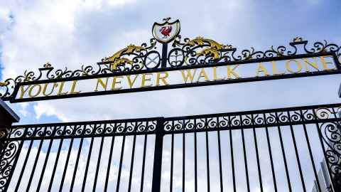 Wrought-iron gates with the words 'You'll never walk alone' at the top.