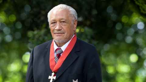 An older man with a medal around his neck.