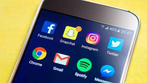 A smartphone screen with app icons including Facebook, Snapchat and Gmail.