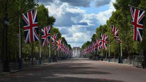 The Mall lined with Union Jacks and Buckingham Palace in the distance.