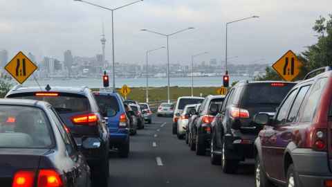 A line of cars waiting for lights to change on a North Shore motorway on-ramp.