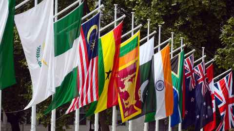 A row of Commonwealth flags flying, including India's, New Zealand's and the United Kingdom's.
