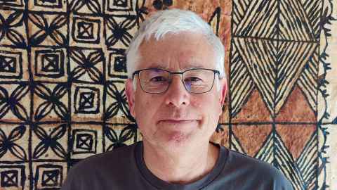 Professor Michael Dragunow in front of tapa cloth.