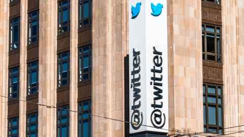 A large office building with a sign that reads '@twitter'.