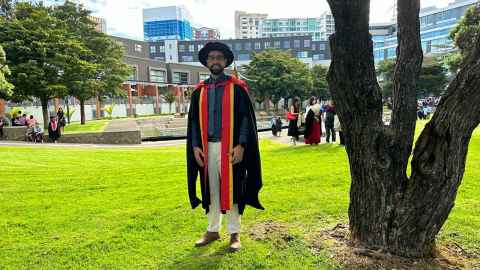 Igor Felippe in his doctoral garb near Spark arena.