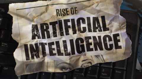 A paper with the headline "Rise of artificial intelligence" lying on a computer keyboard.