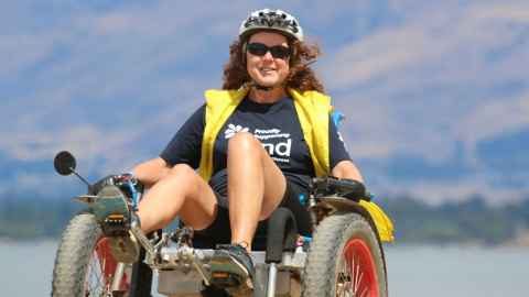 Natalie Gauld on her Motom, a sit-back bike with pedals, that looks like a high-tech pedal car.