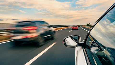 Cars driving along a road.