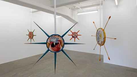 Images with spikes around them, hanging from the ceiling.