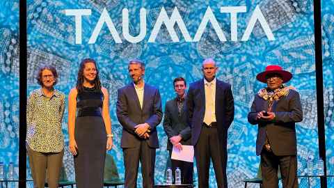 Six people in front of a blue background with the word 'Taumata' at the top.