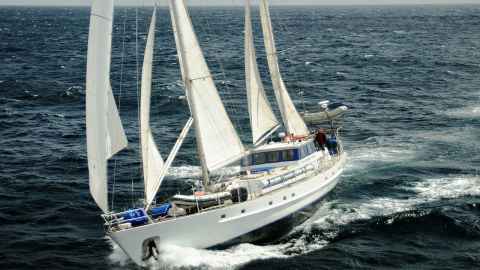 A picture of SV Evohe sailing across open ocean.