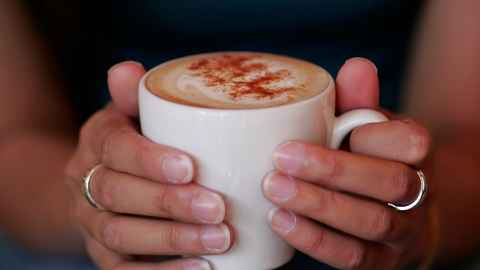 Hands holding a cup of coffee 