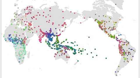 A white and grey map of the world covered with red, green and blue dots.