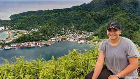 Natalia Palamo on top of Mount Alava on Tutuila Island, with a view of the Port of Pago Pago. 