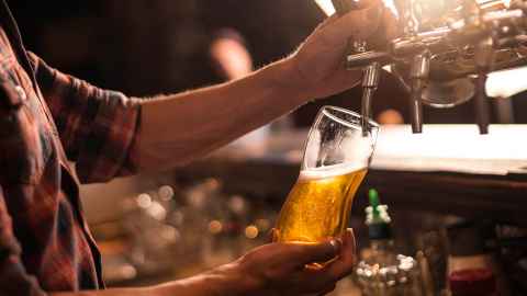A bartender pouring a beer.