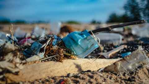 Rubbish, including surgical masks, left on the ground.
