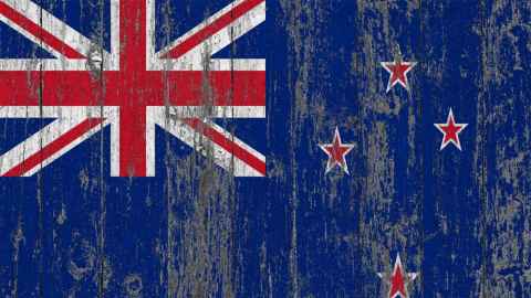 NZ flag painted on worn wooden background