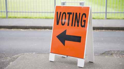 An orange sign with the word 'voting' on it, and an arrow.