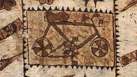 The three historic barkcloth examples on loan to the ‘Amui ‘i Mu‘a – Ancient Futures exhibition feature gramophones, bicycles, and the crown of the late Queen Elizabeth II.
