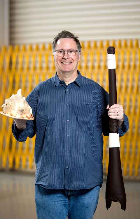Olaf Diegel has printed and is holding replicas of two highly prized taonga pūoro (traditional Māori instruments).
